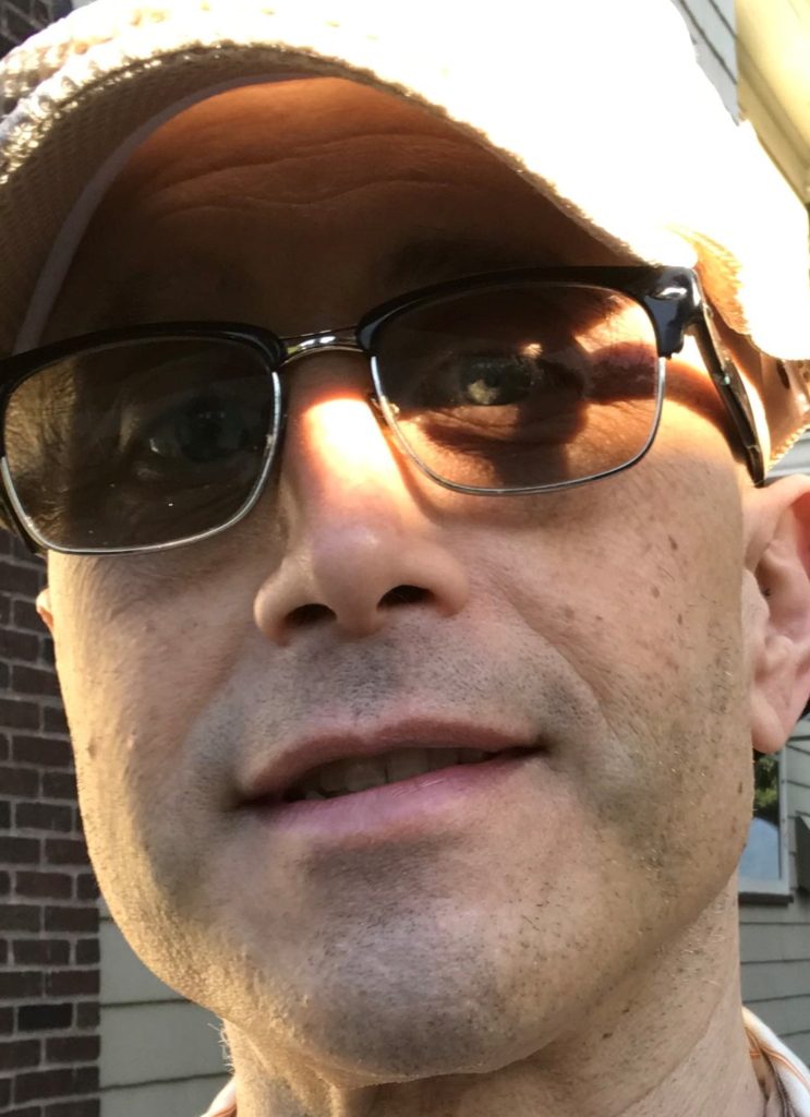 face of Alessandro James Perriello wearing sunglasses and cap